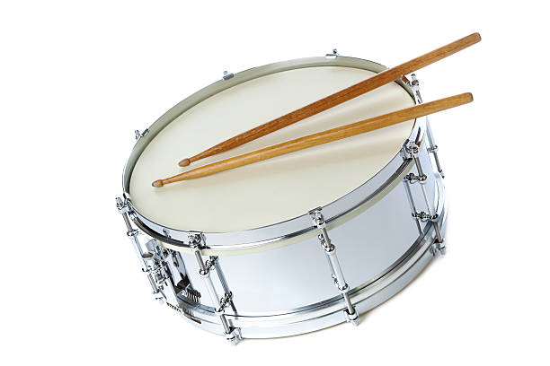 A silver chrome snare drum with drum sticks. The percussion musical instrument is isolated on a white background.